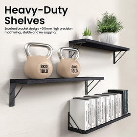 Bayka black wood shelf adds storage and clean lines to a bedroom.