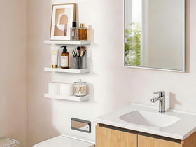 White BAYKA shelves brighten a bedroom by showcasing books and decor without crowding.