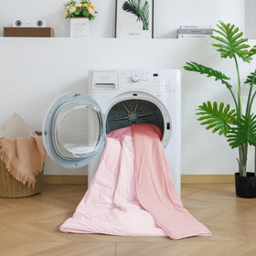 BEAUTEX cooling comforter draped over chair demonstrates all-season versatility.