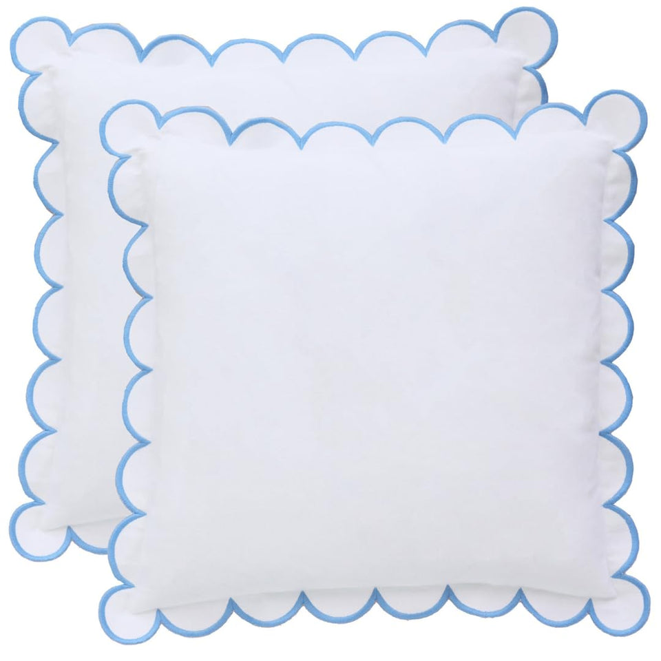 Bebe Bask Margot scalloped pillow cover in white and blue adds timeless elegance to any sofa.