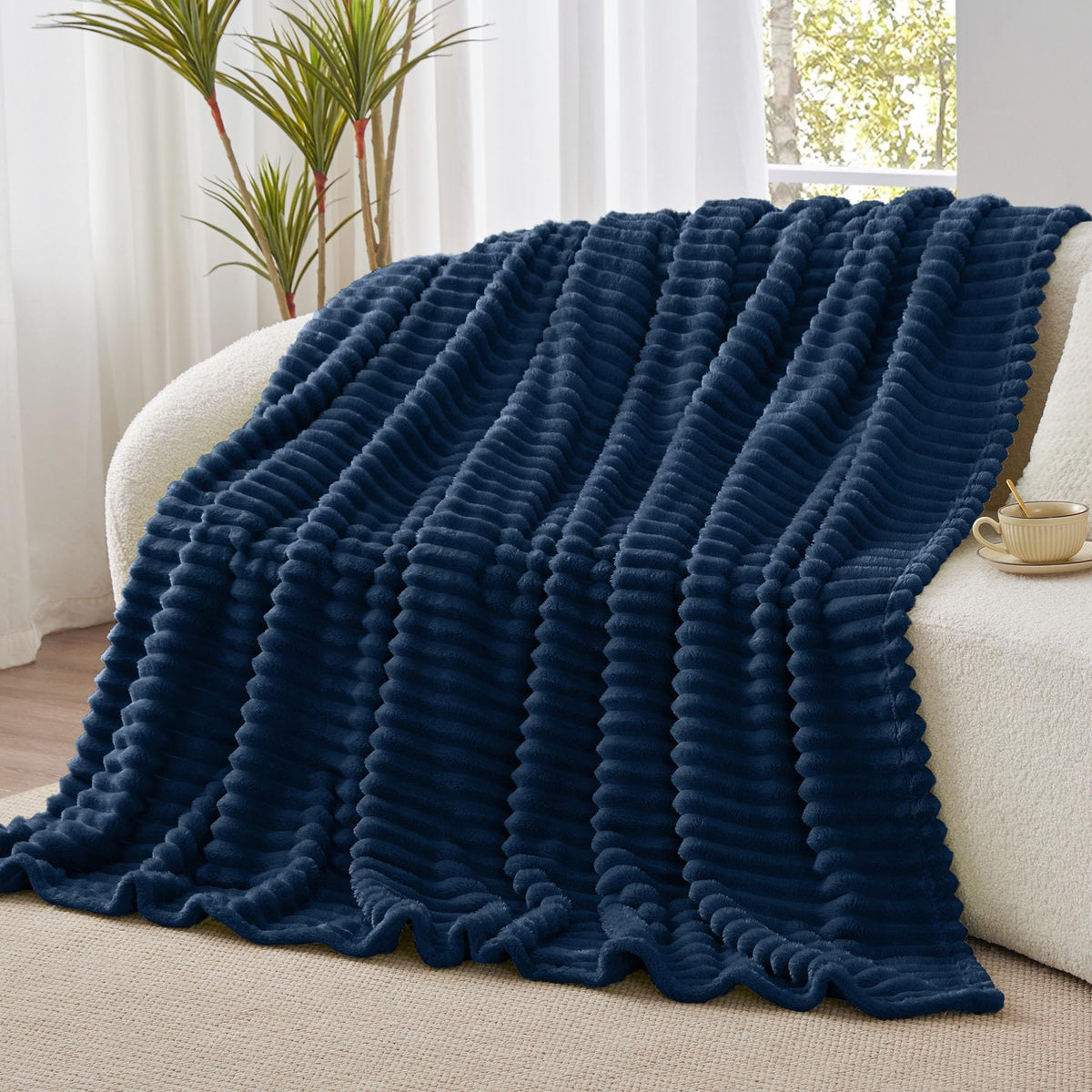 Cozy movie night with BEDELITE navy blanket draped over shoulder
