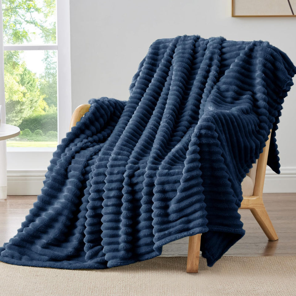 BEDELITE fleece throw blanket in navy on a couch for cozy warmth