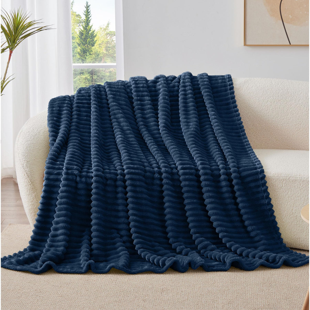 Room decor shot featuring BEDELITE navy stripe blanket on accent chair