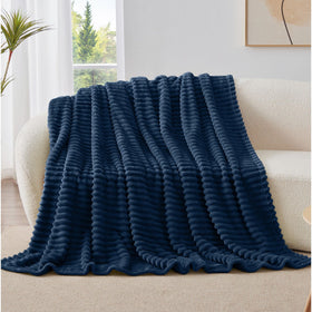 Room decor shot featuring BEDELITE navy stripe blanket on accent chair
