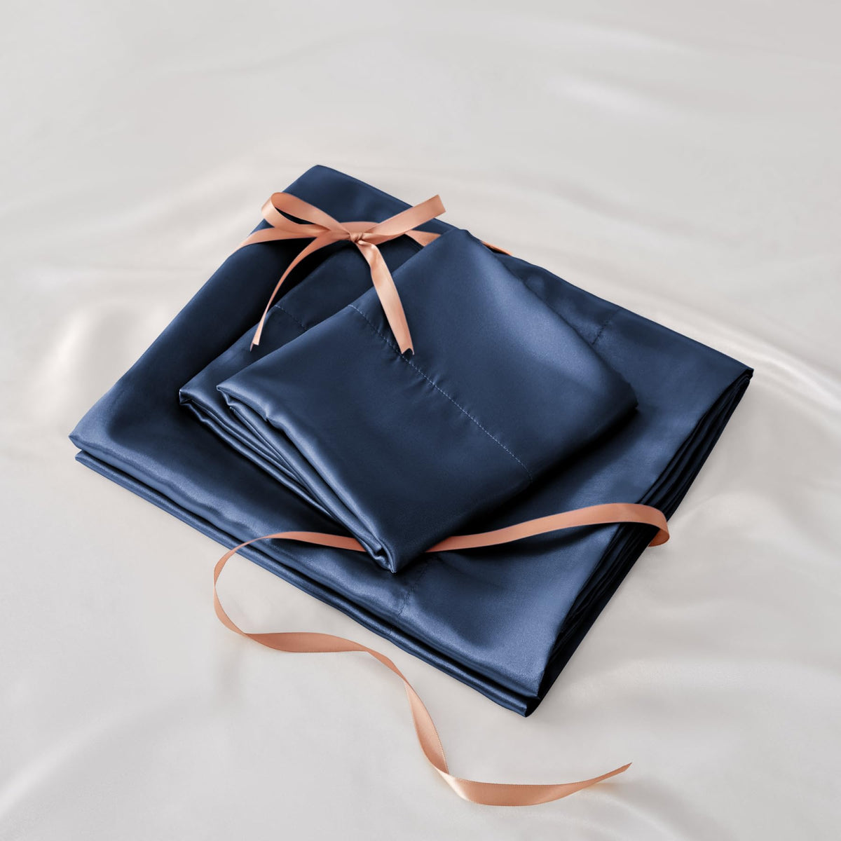 Navy BEDELITE satin sheets add sophisticated, luxurious bedroom style