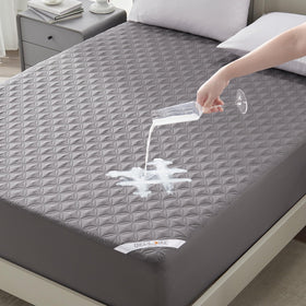 Bedlore coin-pattern waterproof mattress protector shields a California King bed from spills.