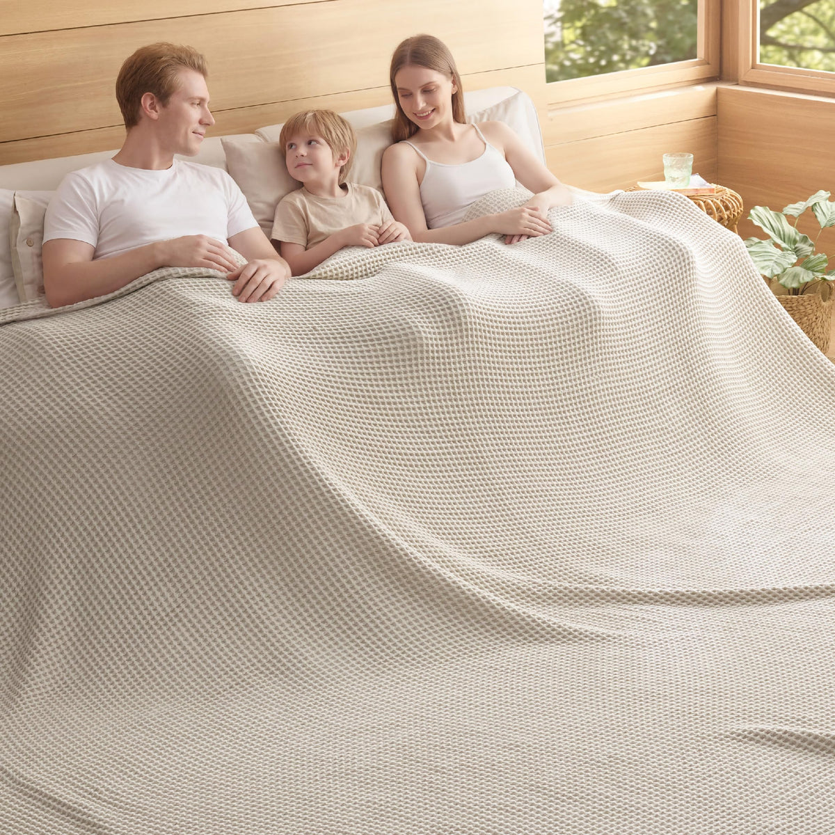 Bedsure 100% cotton oversized king blanket draped on a couch for cozy living room warmth