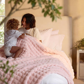 Bedsure pink bubble blanket draped over a chair for cozy bedroom decor