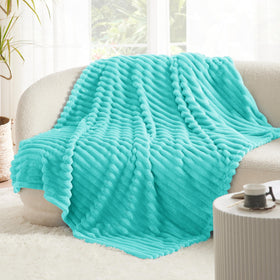 Bedsure Blue Fog fleece blanket on chair in living room for warmth