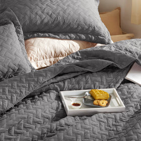 Bedsure bedroom ambience with grey quilt invites cozy, tidy décor.