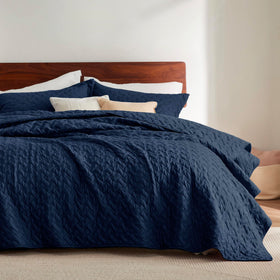 Bedsure California King quilt in navy with basket weave pattern offers year-round comfort.
