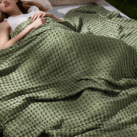 Bedsure cooling cotton waffle blanket in olive green folded for layering and year-round comfort.