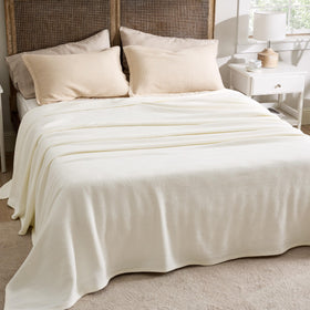 Bedsure cream blanket used as a couch cover for a refined look.