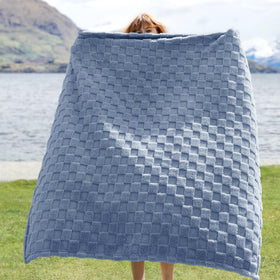 Bedsure GentleSoft Ashley Blue Throw folded on sofa, ideal for quick warmth during movie nights.