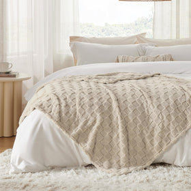 Bedsure GentleSoft beige throw in a bedroom decor setting.
