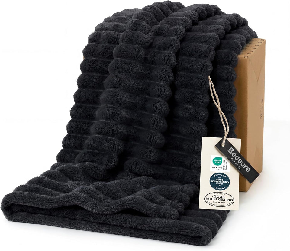 Bedsure GentleSoft Black Throw Blanket draped on a bed for cozy warmth and style.