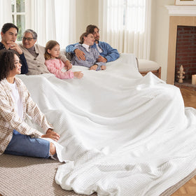 Bedsure Gentlesoft blanket draped over a sofa provides a lightweight, versatile couch cover.