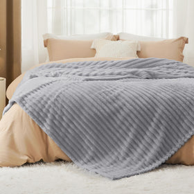 Bedsure GentleSoft king-size blanket drapes over bed with generous coverage