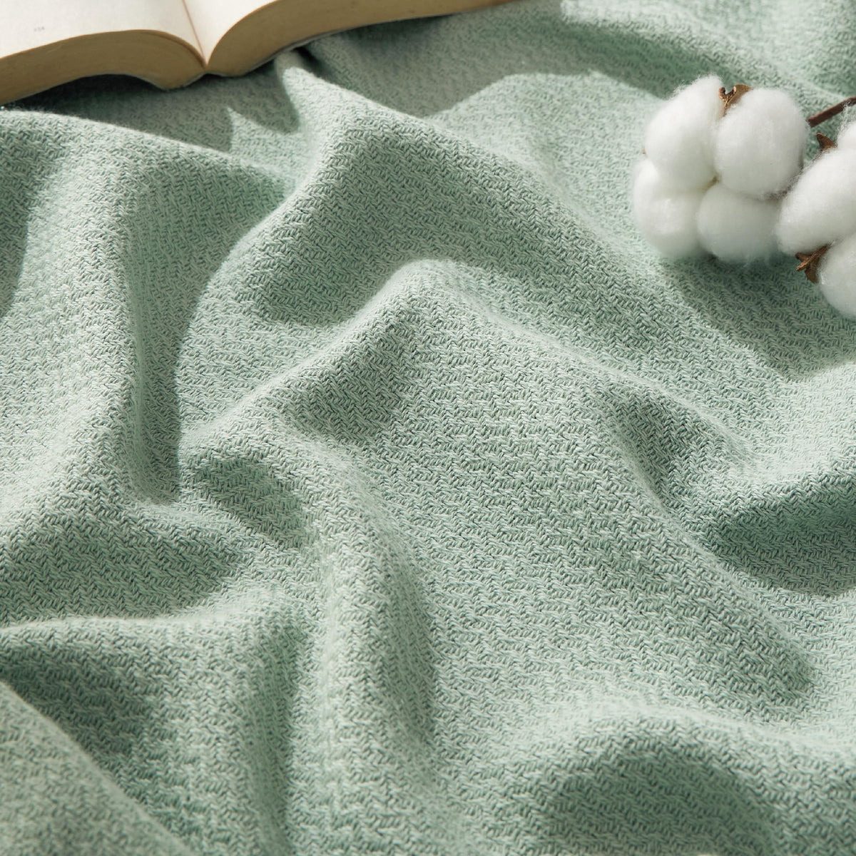 Bedsure GentleSoft blanket in sage green draped on bed, highlighting elegant color and queen-size coverage.