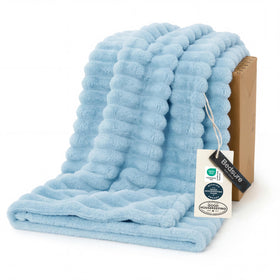 Bedsure GentleSoft blue fleece blanket on couch provides cozy warmth for movie nights.
