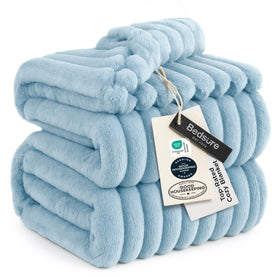 Bedsure GentleSoft blue fleece blanket on couch showing cozy warmth and style