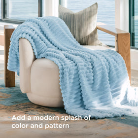 Bedsure GentleSoft blue fleece blanket with stripe design enhances decor and comfort.