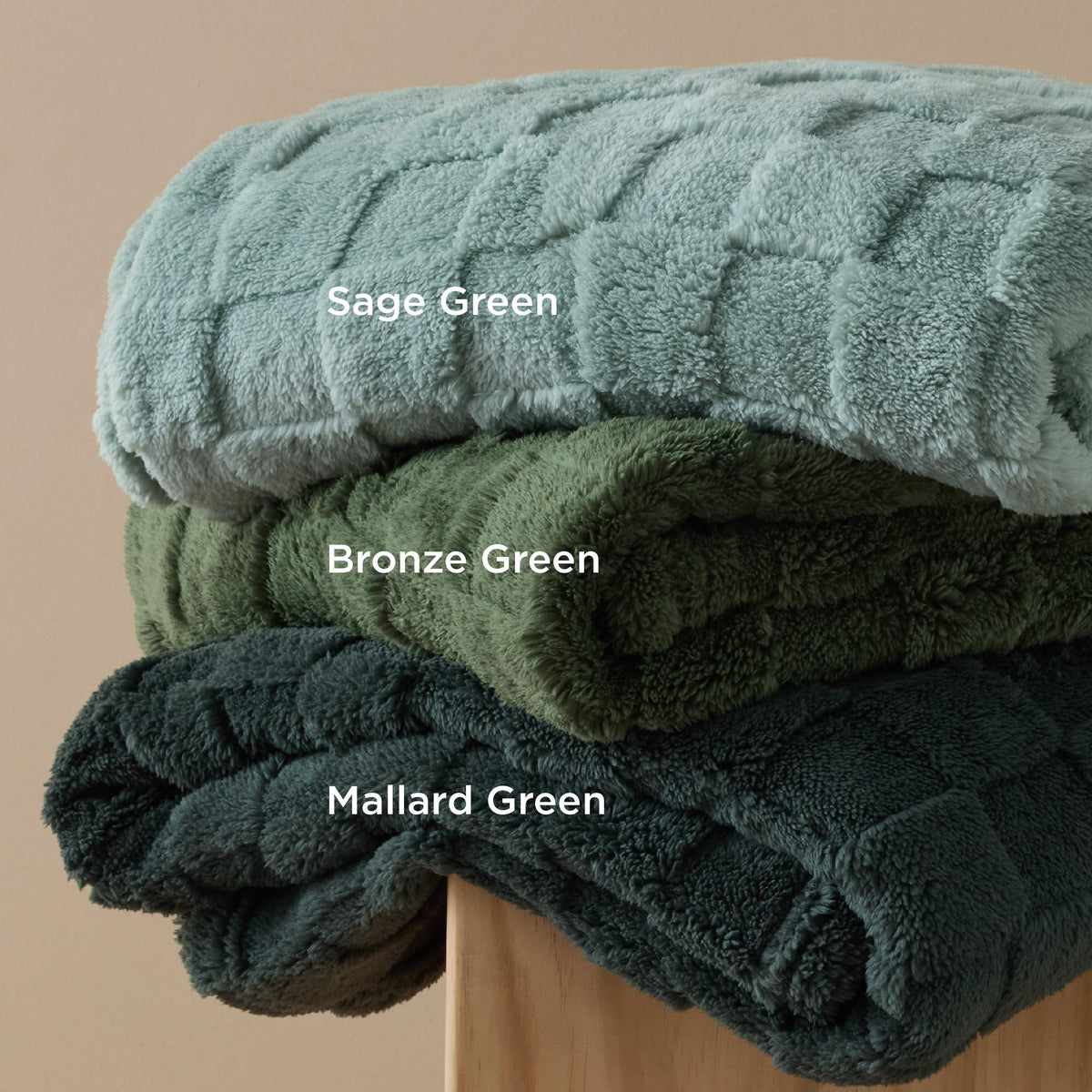 Bedsure GentleSoft Bronze Green Throw Blanket in a dorm room setup