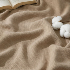 Bedsure GentleSoft cotton blanket folded on sofa showing breathable, lightweight warmth