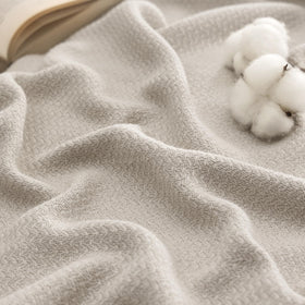 Bedsure GentleSoft cotton blanket in linen beige draped on bed for breathable comfort