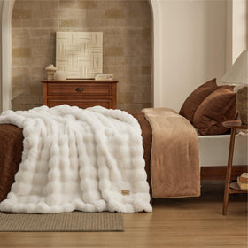 Bedsure GentleSoft cream throw on couch as decorative layer.