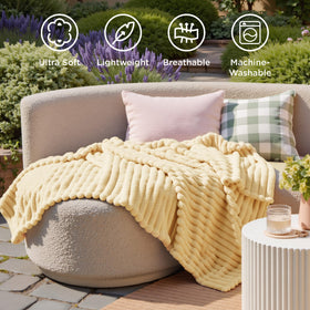 Bedsure GentleSoft custard-yellow throw draped on bed adds warmth.