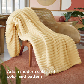 Bedsure GentleSoft custard-yellow throw on couch creates cozy ambiance.