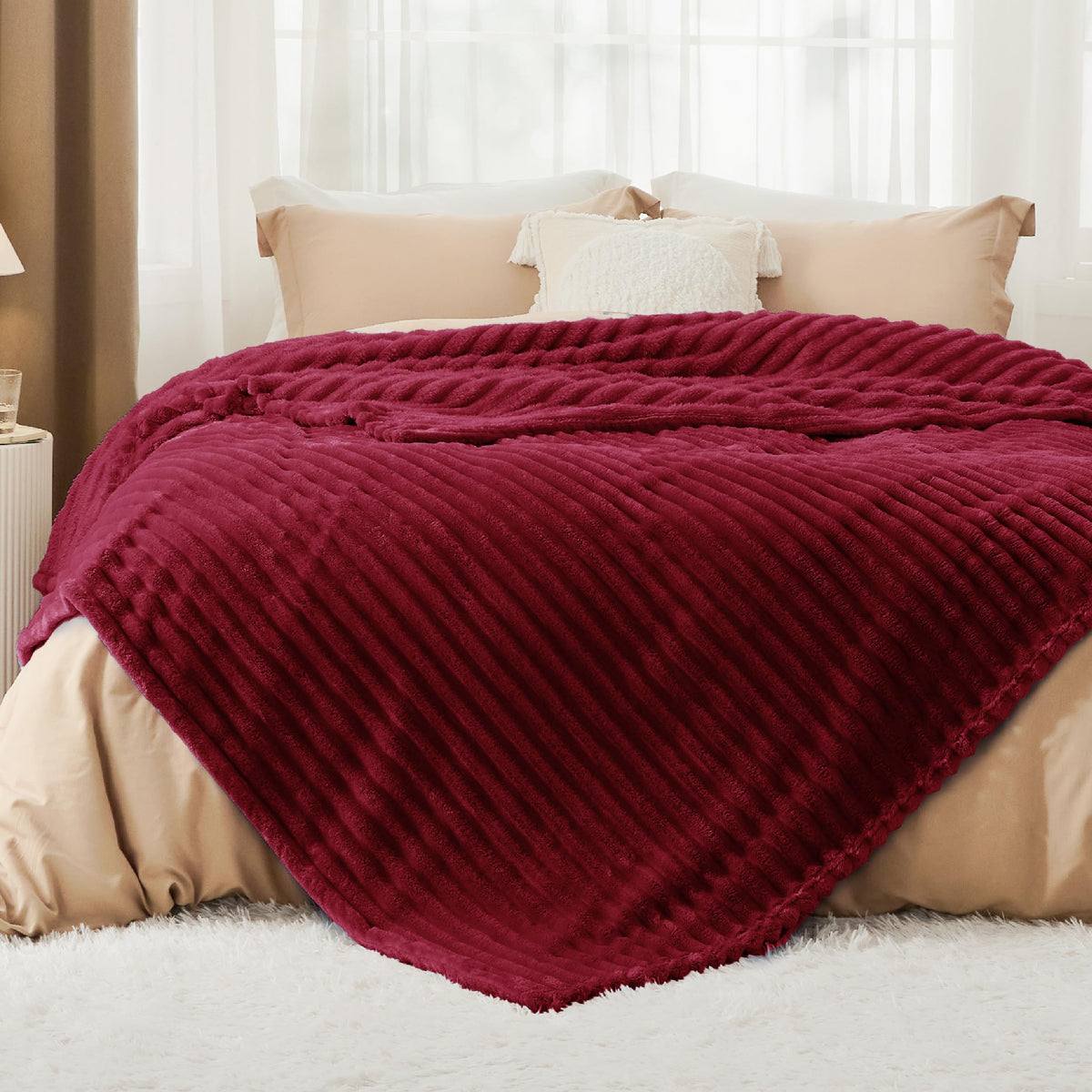 Bedsure GentleSoft Deep Red Blanket folded on sofa for plush comfort.