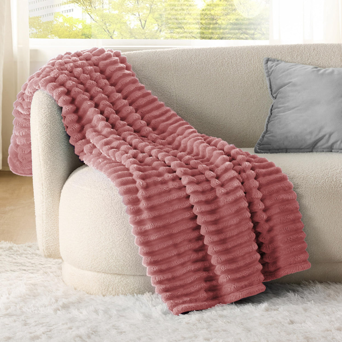 Closeup of Bedsure GentleSoft dusty pink fleece texture showing plush microfiber.