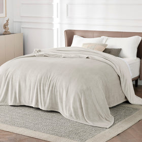 Bedsure GentleSoft fleece blanket laid on a bed in California king size