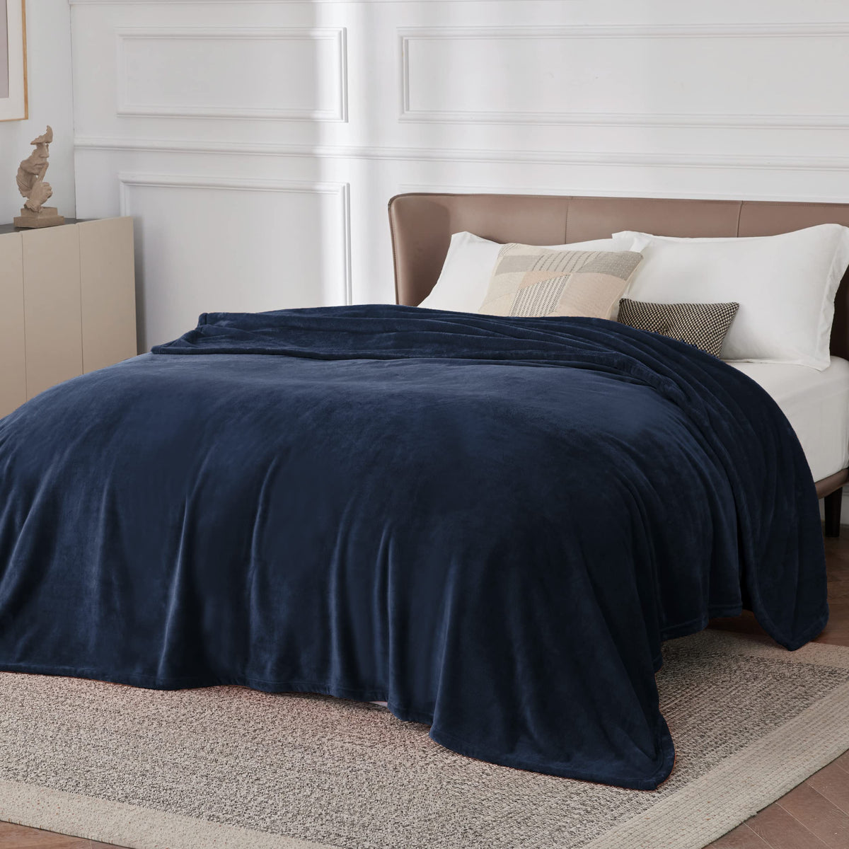 Bedsure GentleSoft navy blanket spread on large bed shows lightweight warmth