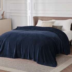 Bedsure GentleSoft navy blanket spread on large bed shows lightweight warmth