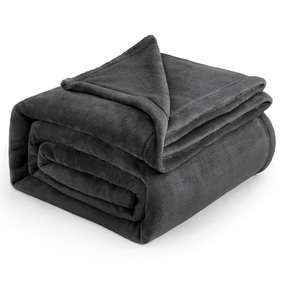 Bedsure GentleSoft fleece blanket king-size folded on bed offering year-round warmth