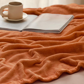Bedsure GentleSoft fleece blanket by the bedside, ideal for quick warmth at night.