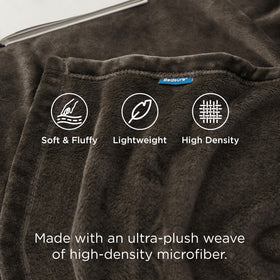 Bedsure GentleSoft fleece blanket draped on couch for cozy evenings.