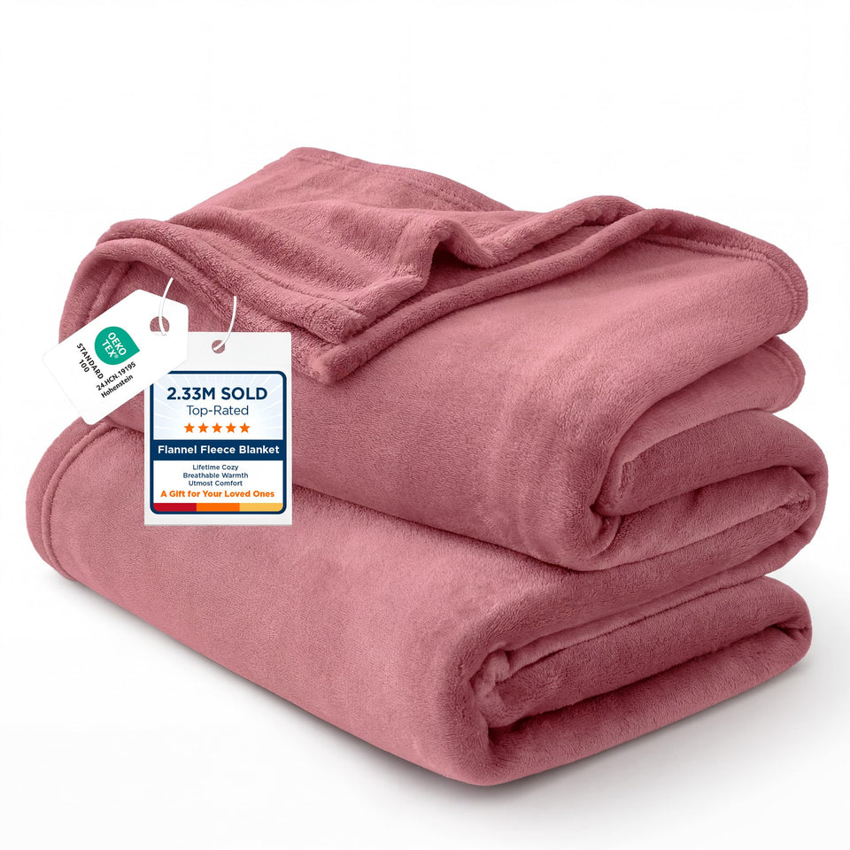 Bedsure GentleSoft fleece blanket dusty rose draped over a bed for warm style.