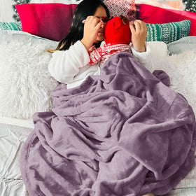 Bedsure GentleSoft fog purple blanket with mug frames a cozy movie night.