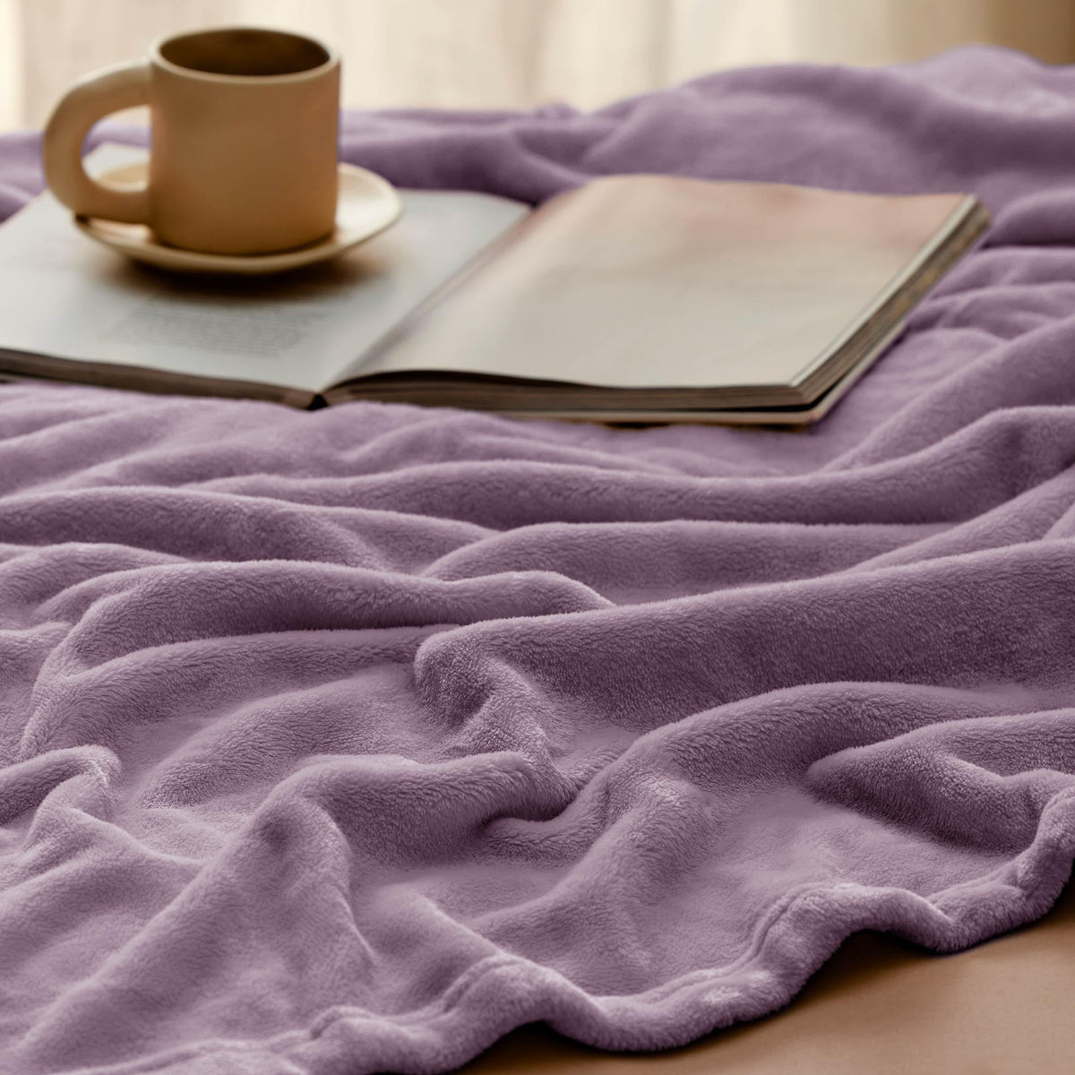 Bedsure GentleSoft fog purple blanket on the sofa provides cozy pet-friendly lounging.