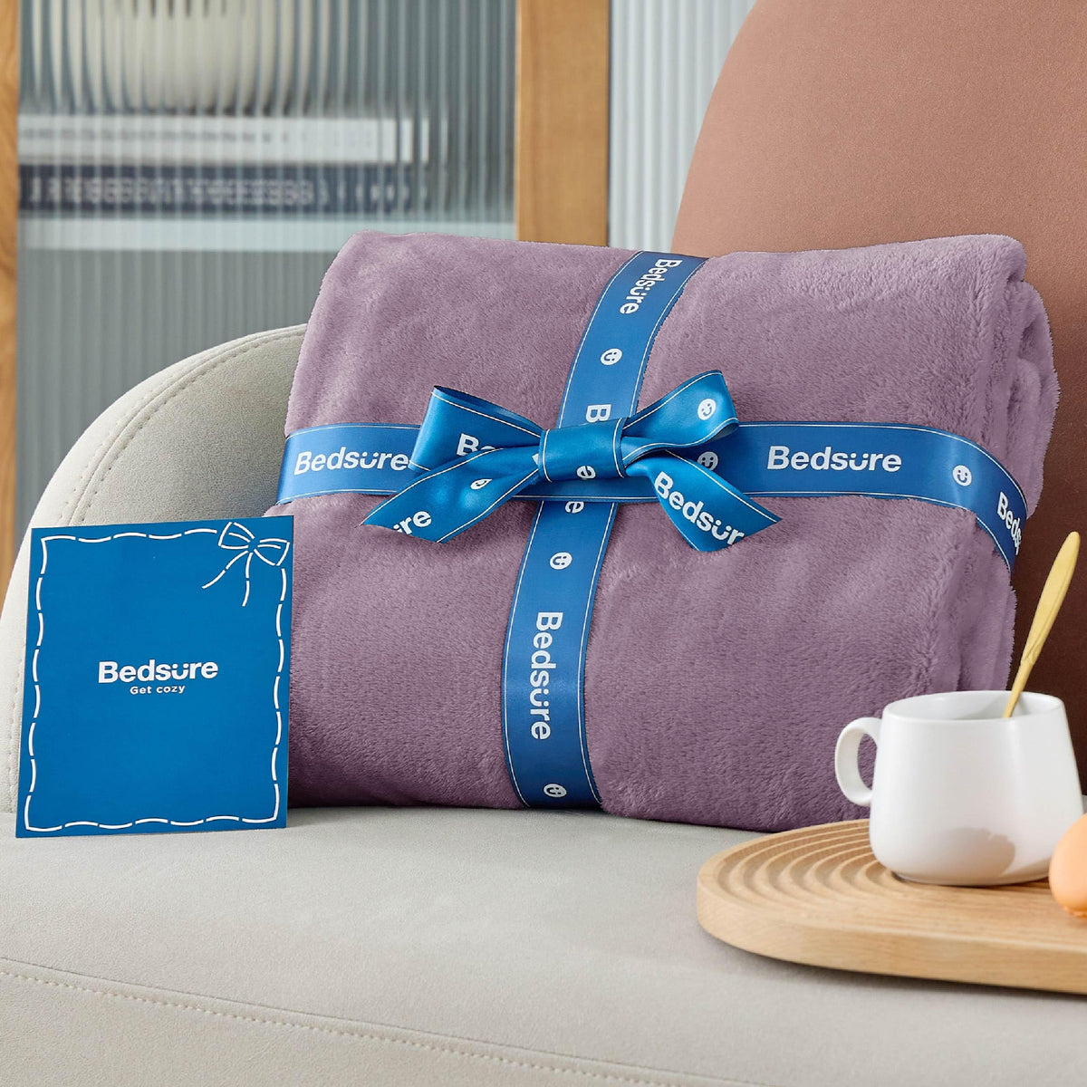 Bedsure GentleSoft fog purple blanket in living room complements decor with breathable warmth.