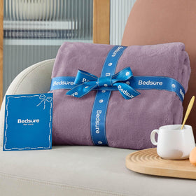 Bedsure GentleSoft fog purple blanket in living room complements decor with breathable warmth.