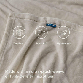 Bedsure GentleSoft fleece blanket on a bed, showcasing lightweight warmth and drape.
