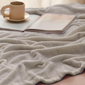 Bedsure GentleSoft fleece blanket with a pet, illustrating cozy cuddle moments.