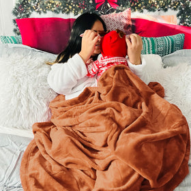 Bedsure GentleSoft fleece blanket draped on a sofa for relaxed movie nights.
