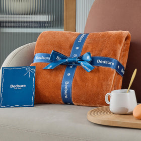 Bedsure GentleSoft fleece blanket rolled for travel, lightweight yet cozy.