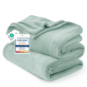 Bedsure GentleSoft fleece blanket sage green full-size on bed for year-round coziness.